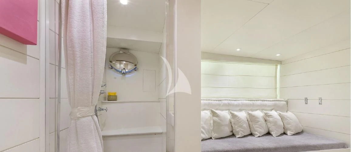 a bathroom with a white bed and a mirror aboard VERVECE Yacht for Charter
