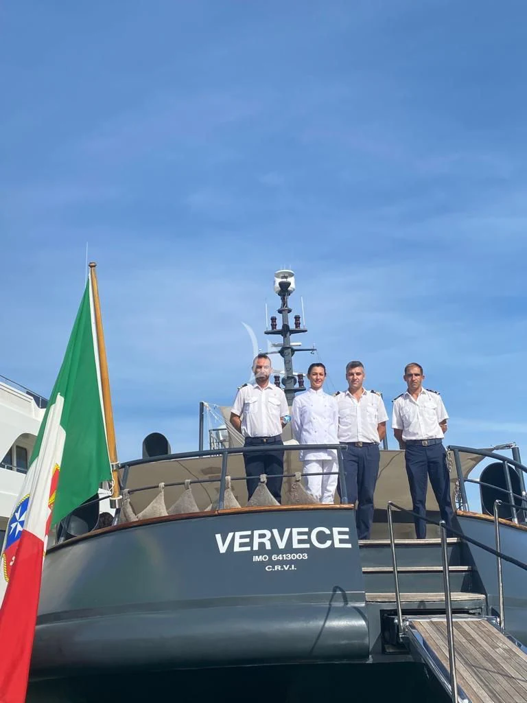 a group of men standing on a boat aboard VERVECE Yacht for Charter