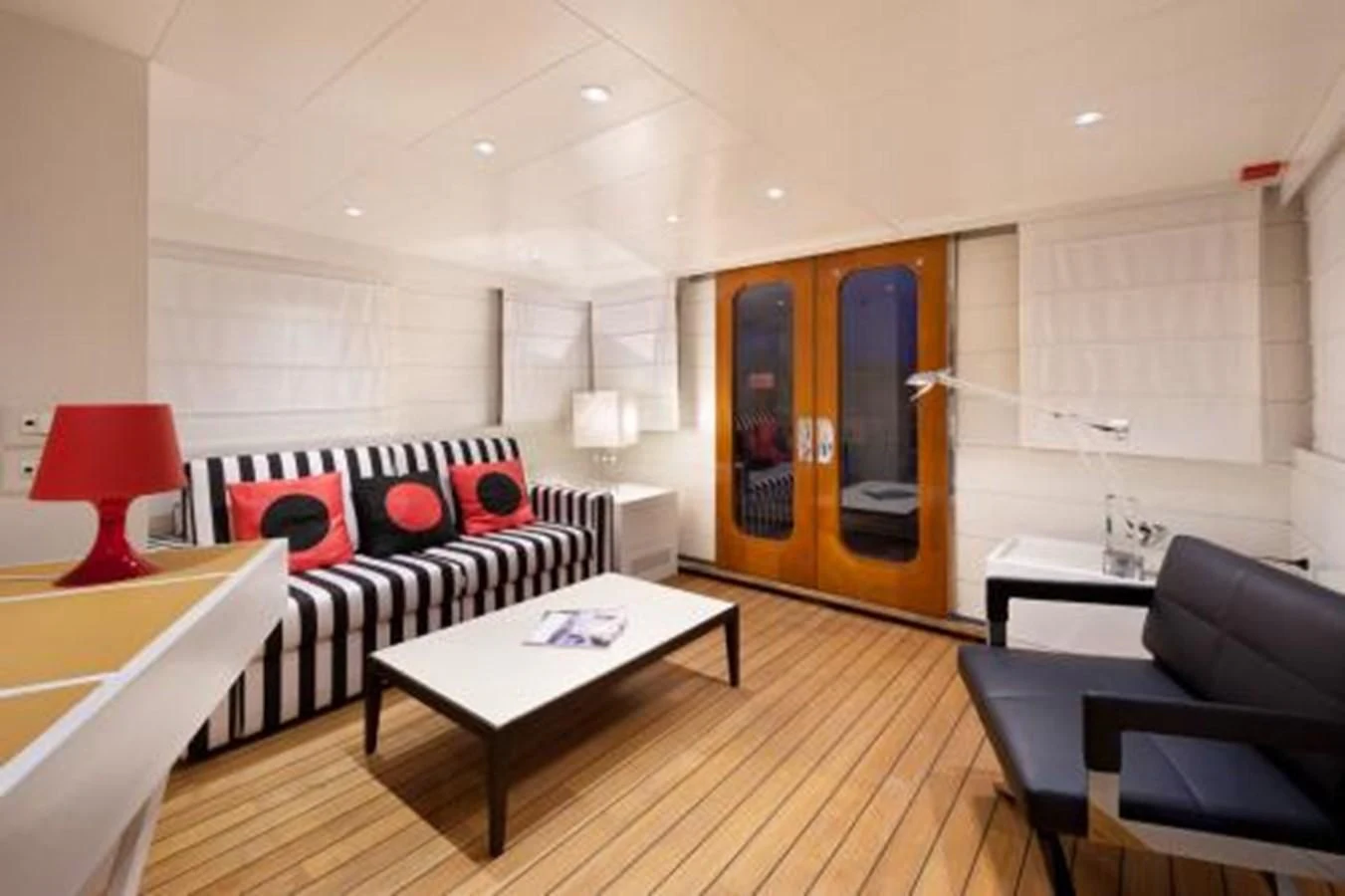 a living room with a wood floor aboard VERVECE Yacht for Charter