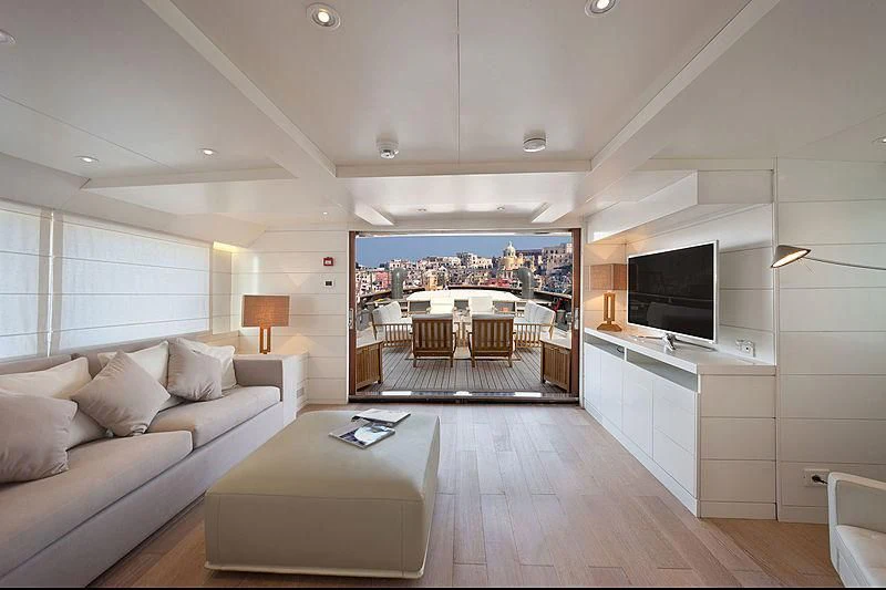 a living room with a large screen aboard VERVECE Yacht for Charter