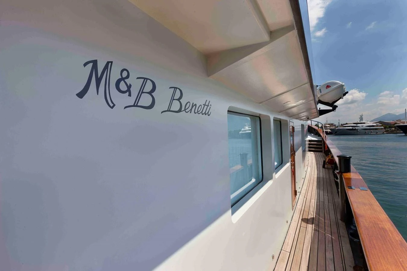 a building with a dock and a body of water aboard VERVECE Yacht for Charter