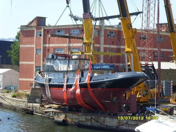 a large red and black boat docked aboard VERVECE Yacht for Charter