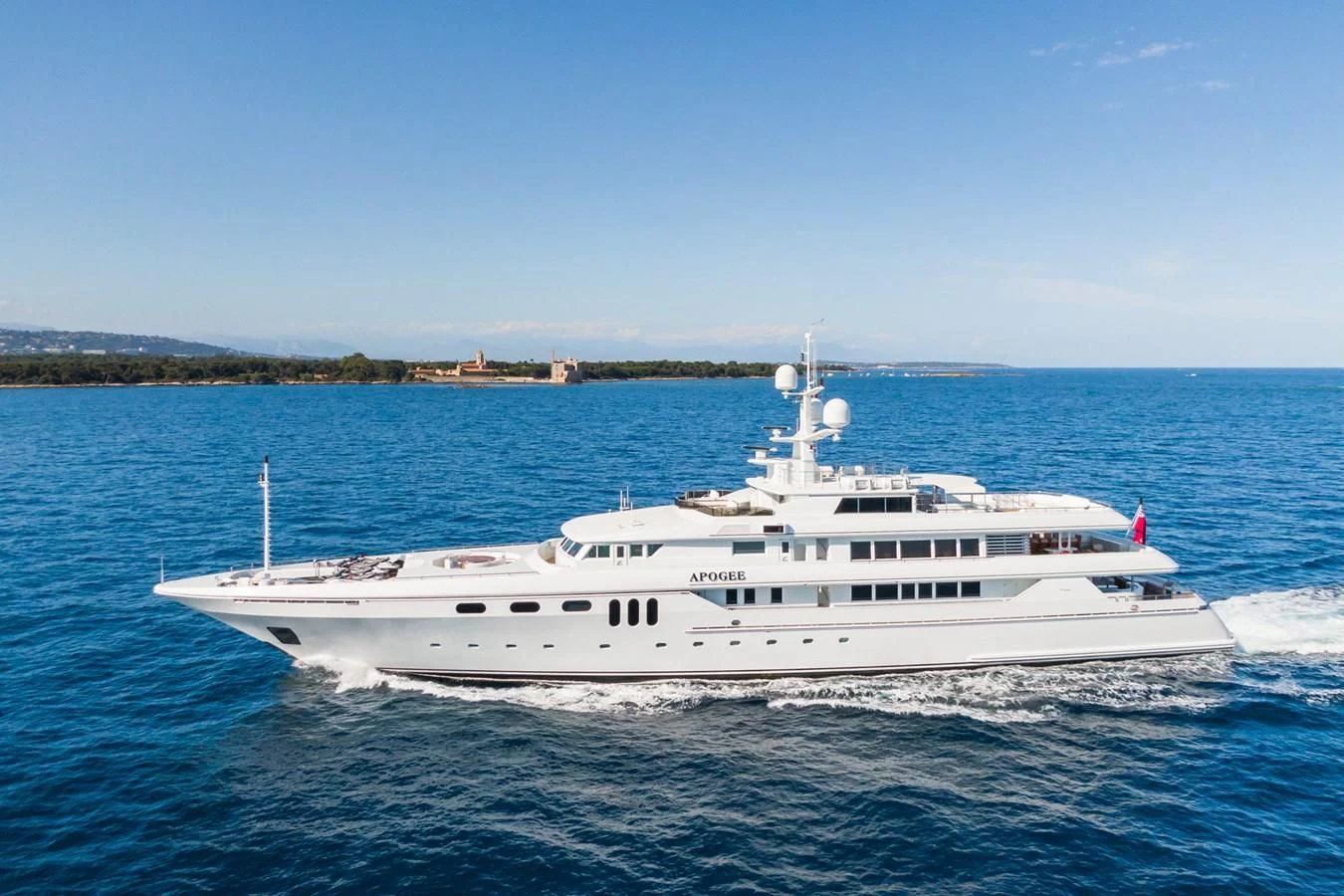 a white boat on the water aboard APOGEE Yacht for Sale