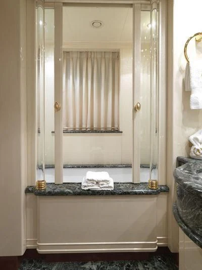a bathroom with a large mirror aboard APOGEE Yacht for Sale