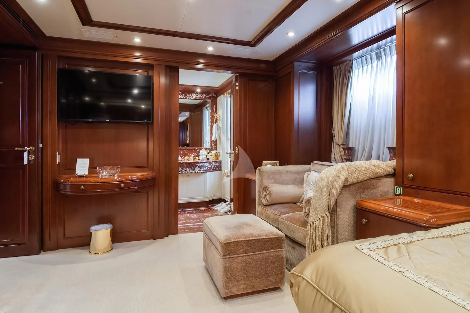 a room with a bed and a chair aboard APOGEE Yacht for Sale