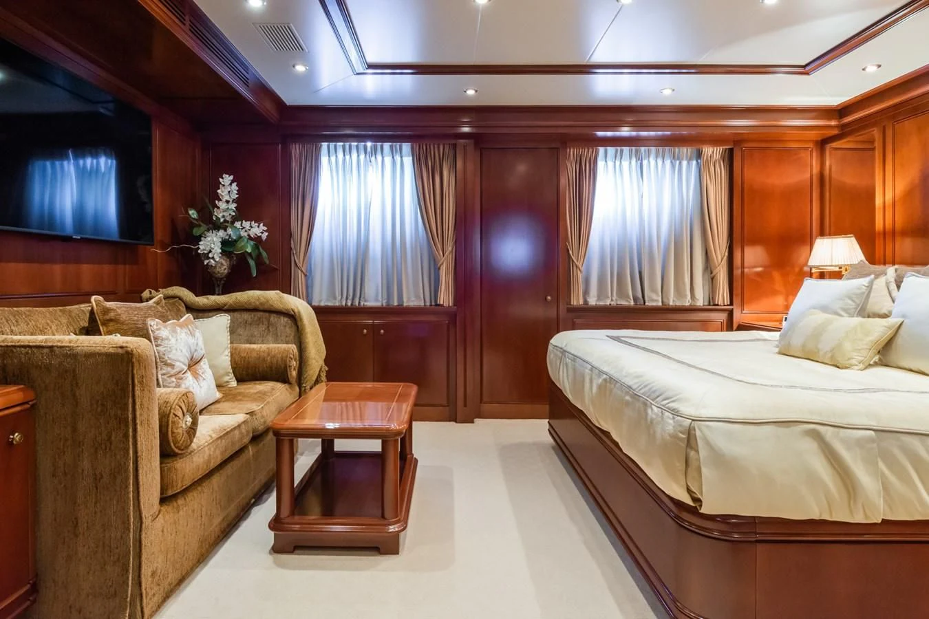 a room with a bed and a couch aboard APOGEE Yacht for Sale