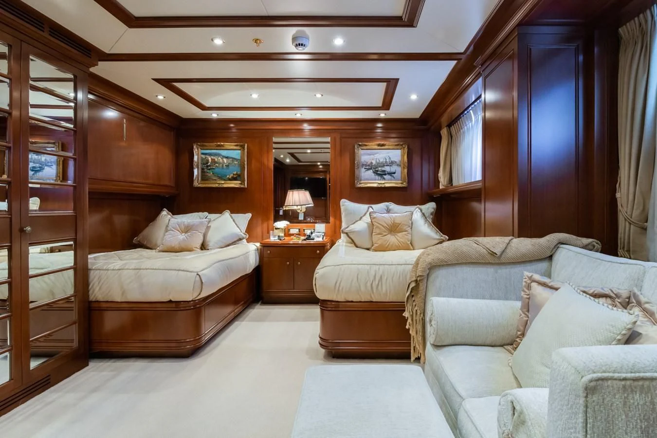 a room with a bed and a couch aboard APOGEE Yacht for Sale