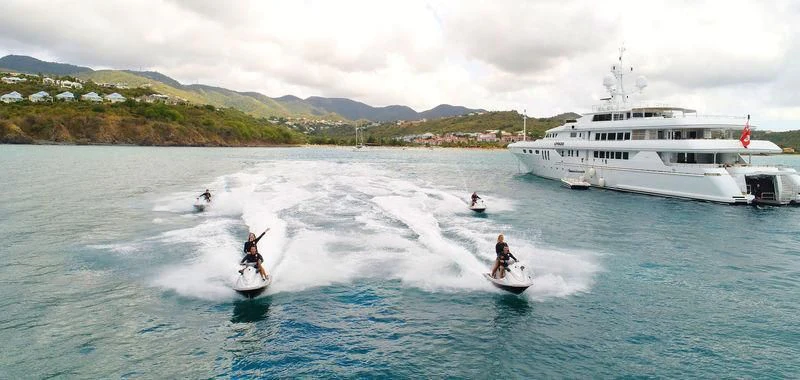 a group of people on surfboards in the water aboard APOGEE Yacht for Sale