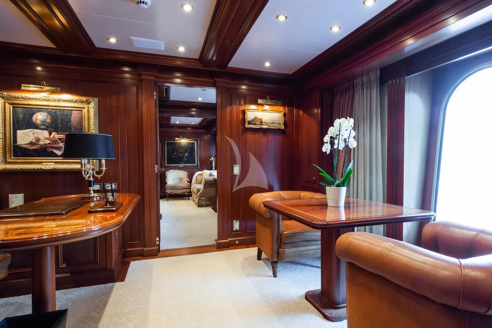 a living room with a fireplace aboard APOGEE Yacht for Sale