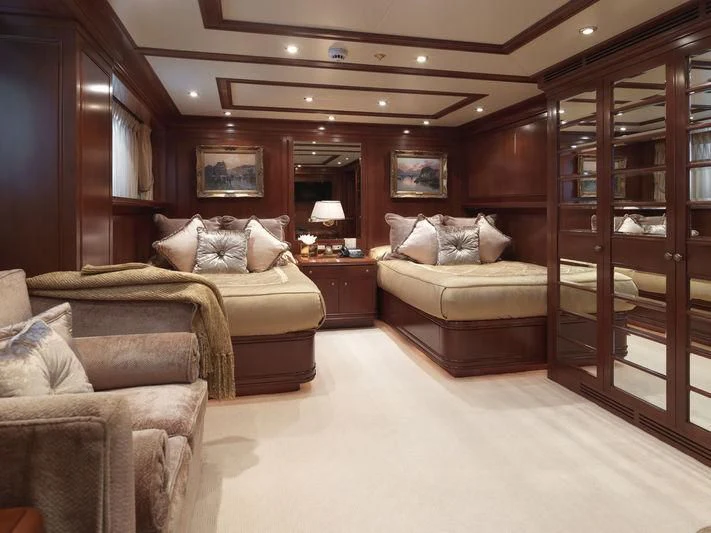 a room with a bed and a couch aboard APOGEE Yacht for Sale