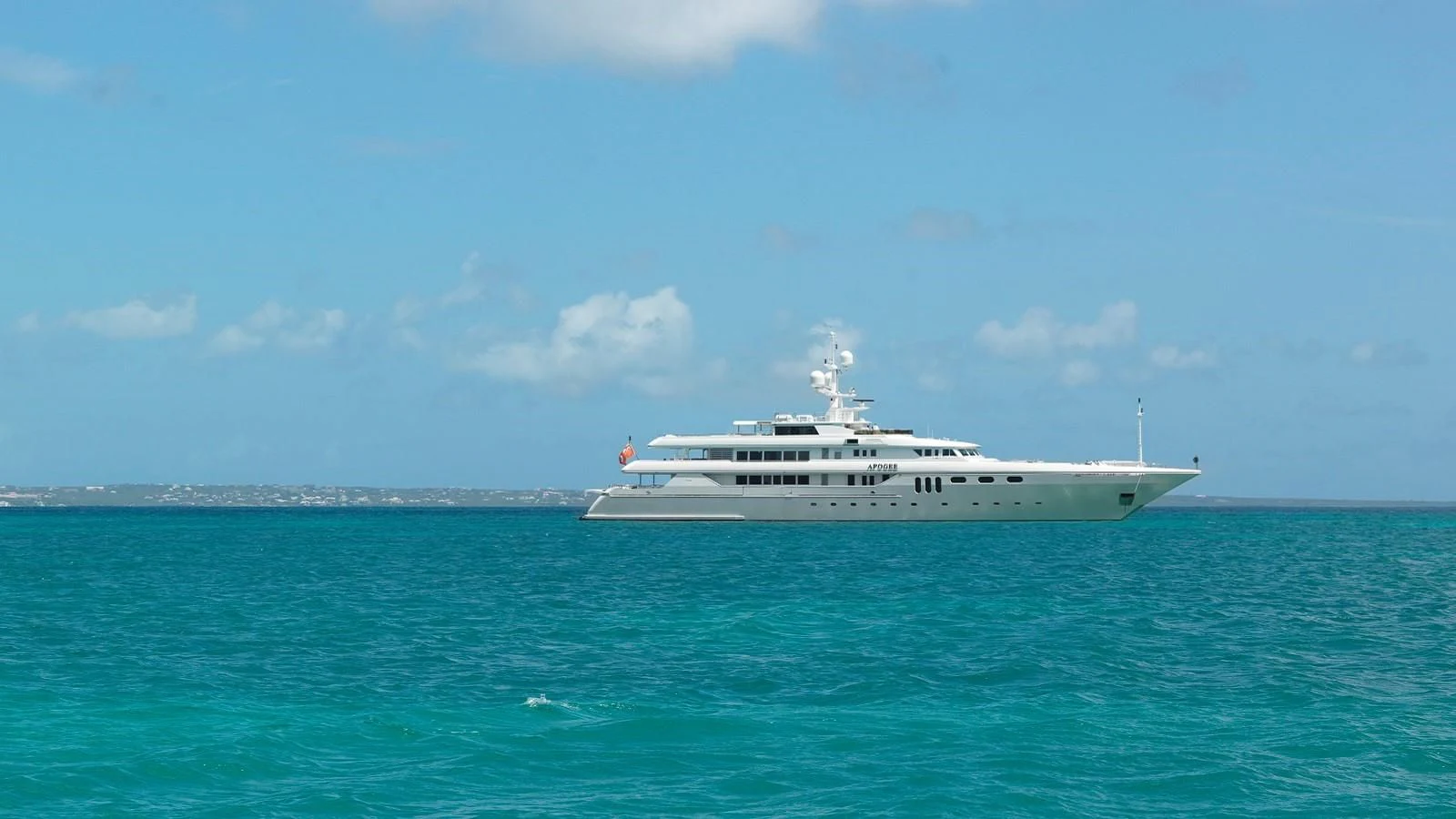 a white yacht in the water aboard APOGEE Yacht for Sale
