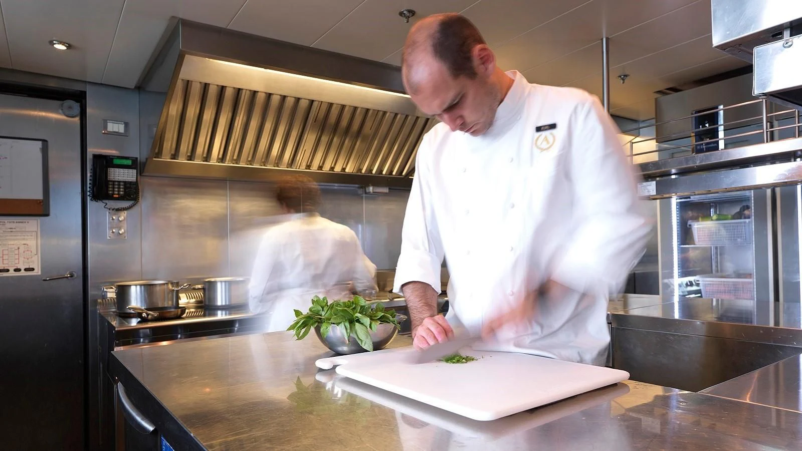 a chef in a kitchen aboard APOGEE Yacht for Sale