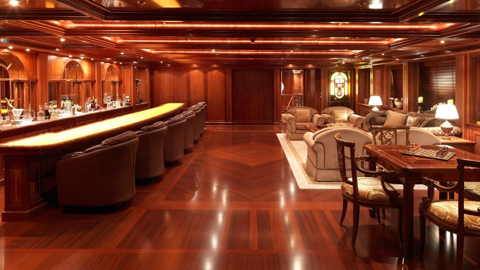 a large living room with a pool table and couches aboard APOGEE Yacht for Sale