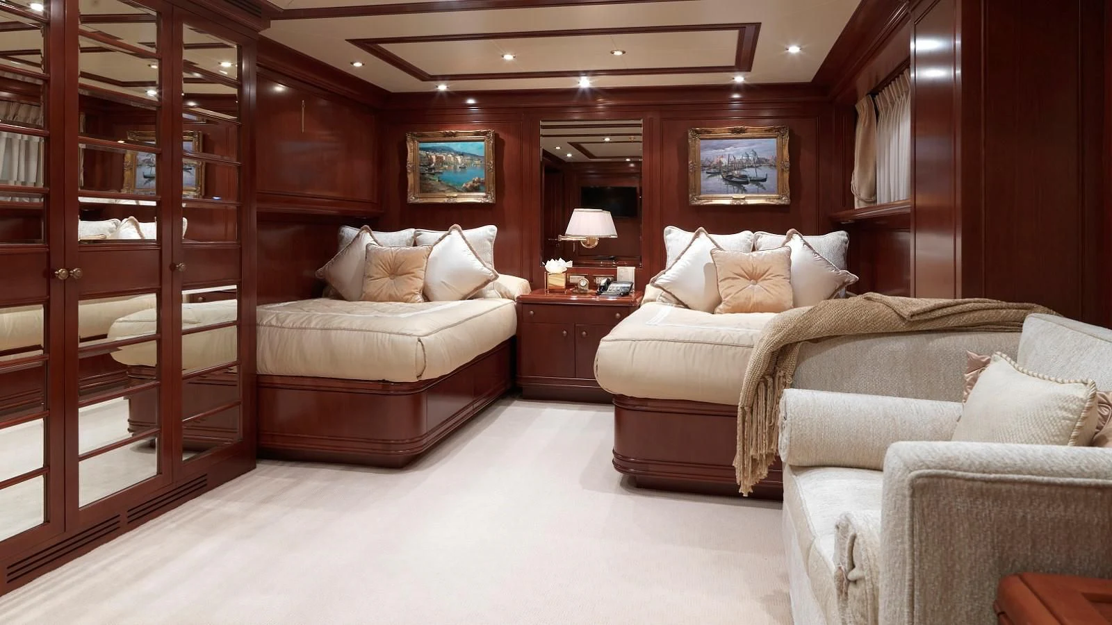 a room with a bed and a couch aboard APOGEE Yacht for Sale