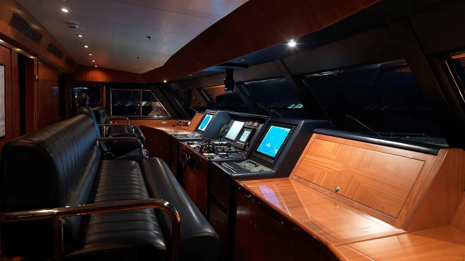 inside of a vehicle with a desk and computer screens aboard APOGEE Yacht for Sale