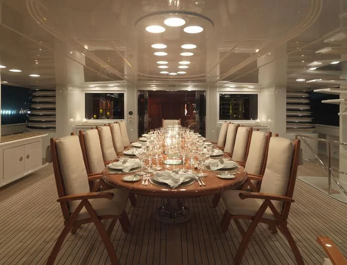 a large dining room with a table and chairs aboard APOGEE Yacht for Sale