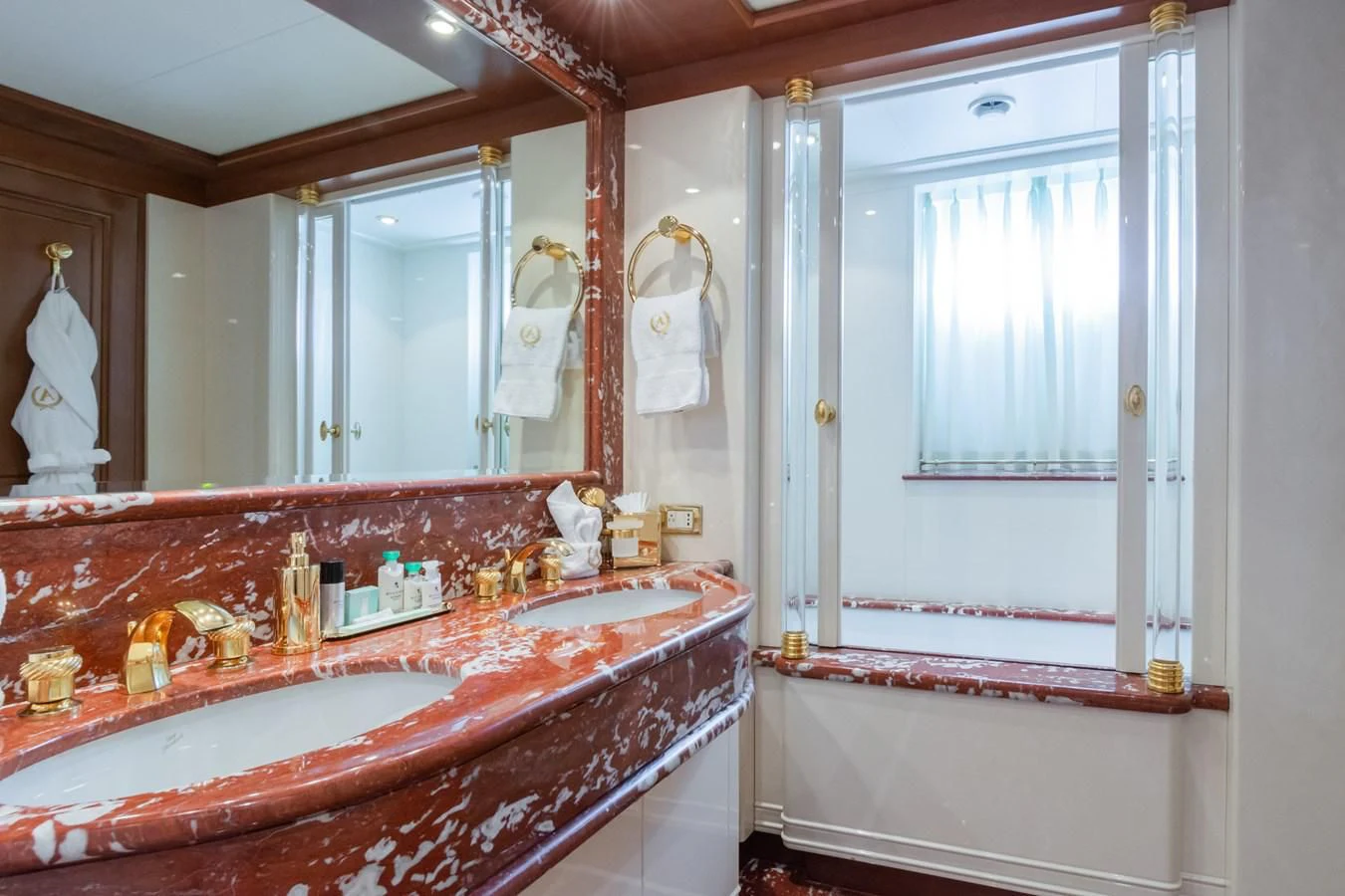 a bathroom with a large mirror aboard APOGEE Yacht for Sale