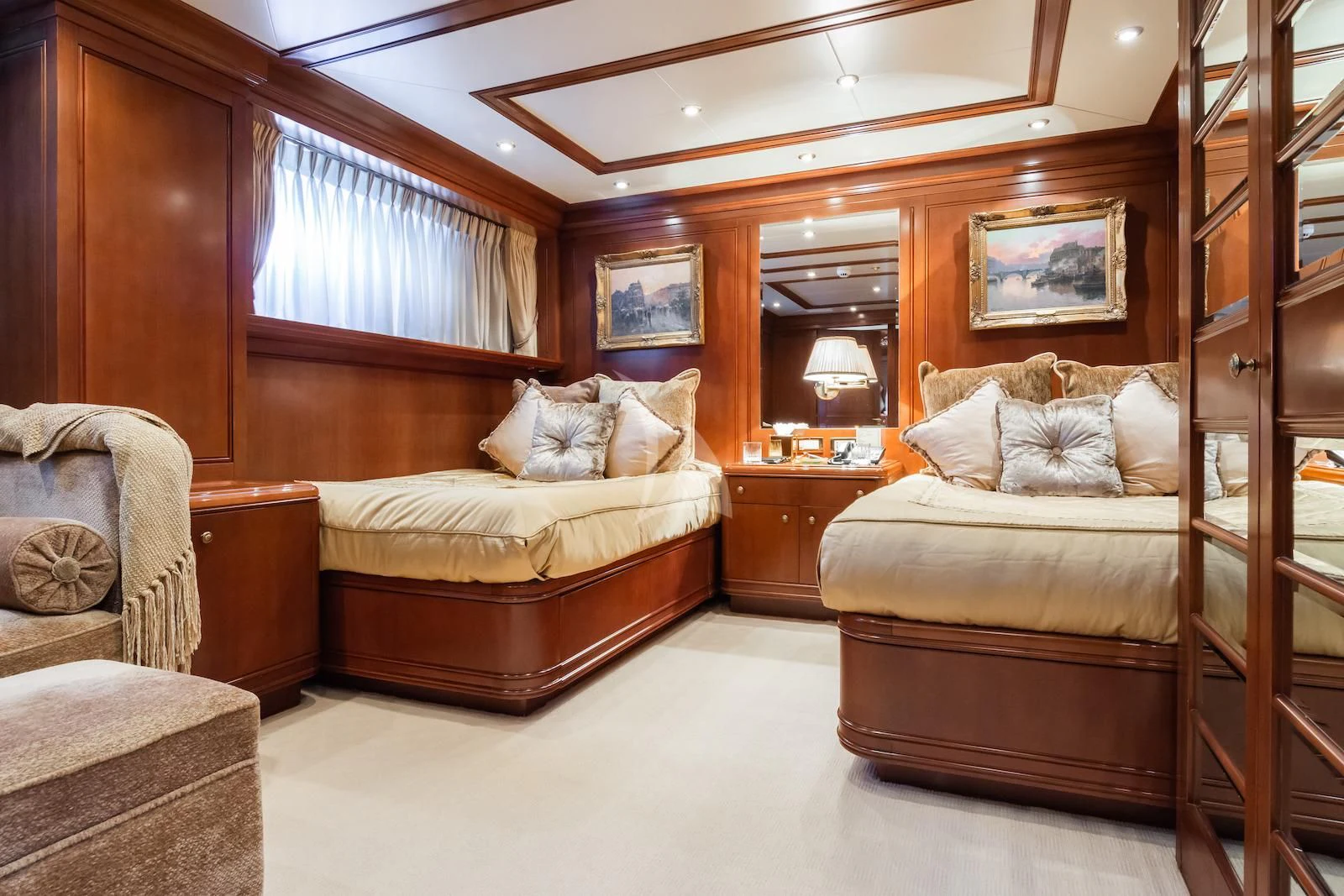 a bedroom with a bed and a chair aboard APOGEE Yacht for Sale