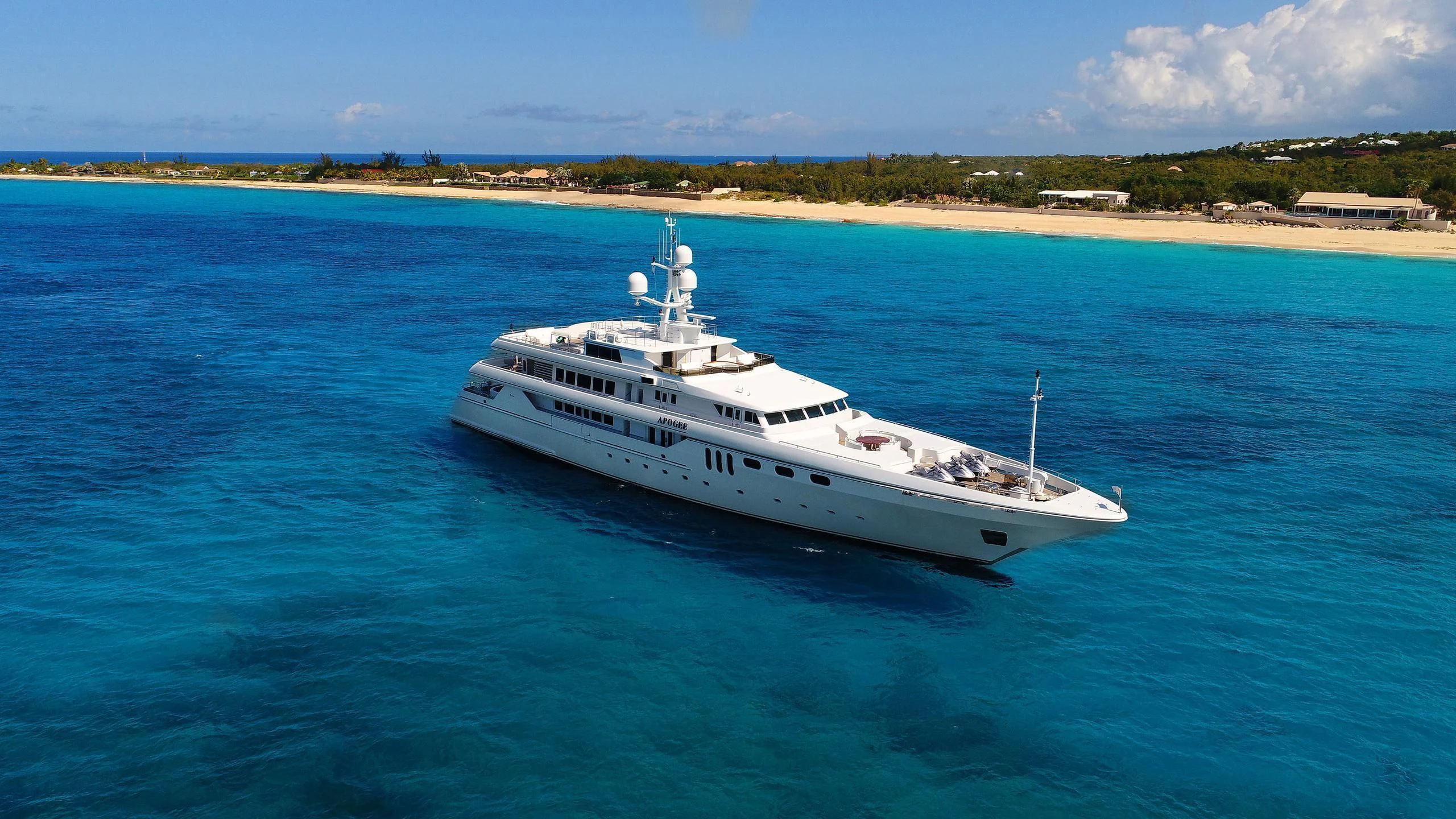a white yacht in the water aboard APOGEE Yacht for Sale