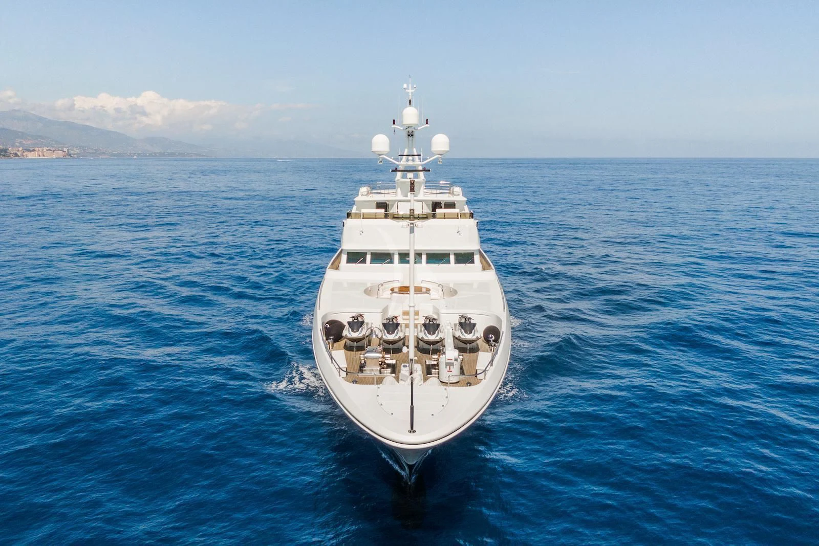 a white boat in the water aboard APOGEE Yacht for Sale