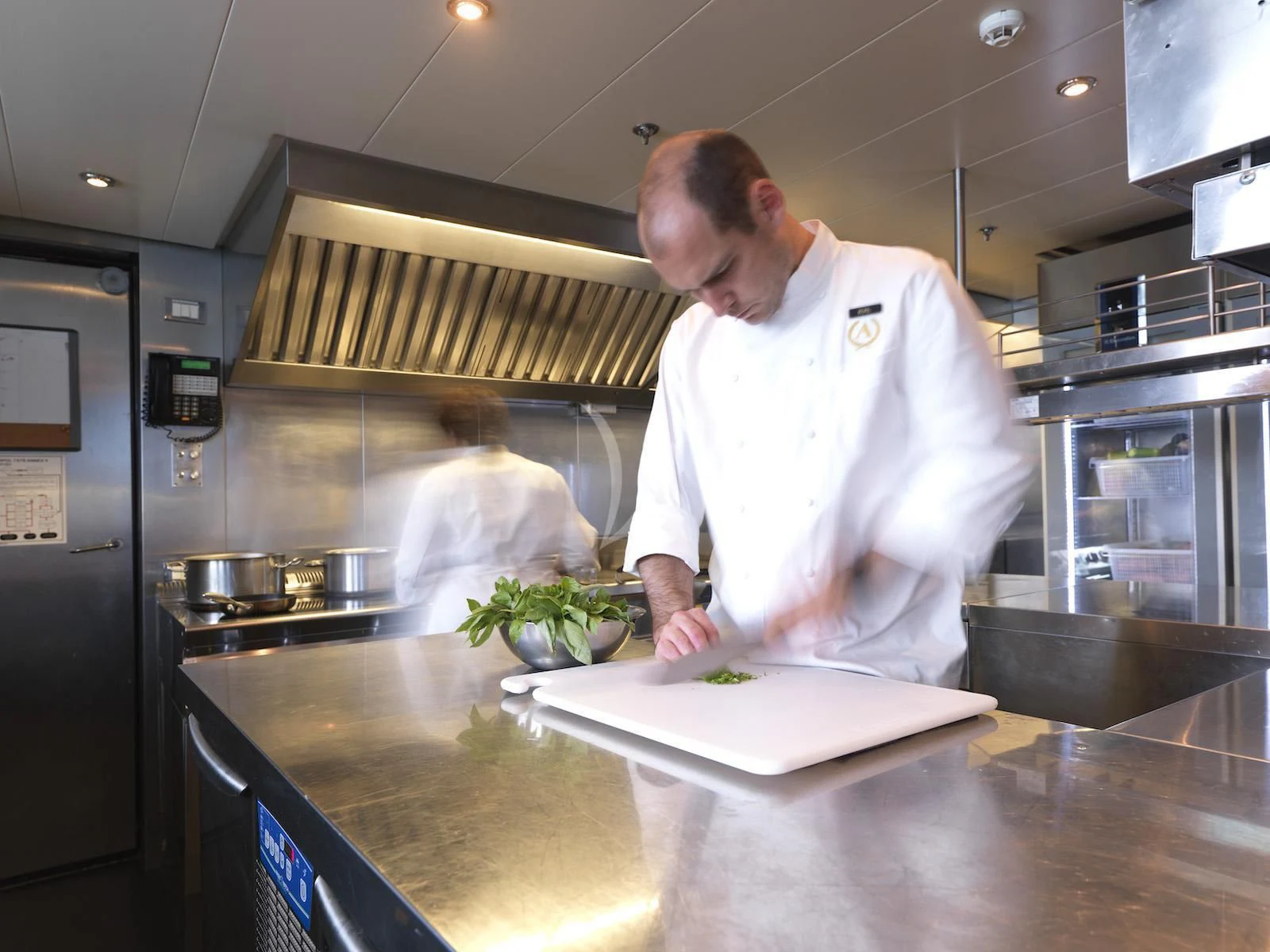 a chef in a kitchen aboard APOGEE Yacht for Sale