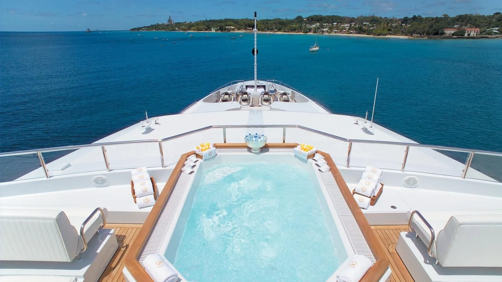 a large white boat with a blue body of water and a beach aboard APOGEE Yacht for Sale