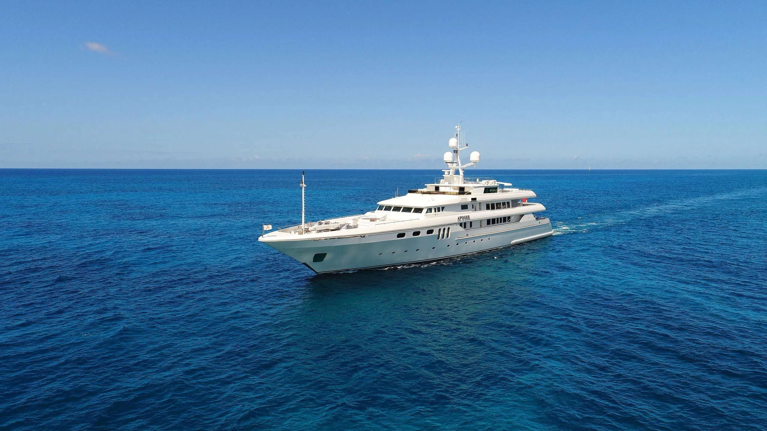 a white boat in the water aboard APOGEE Yacht for Sale