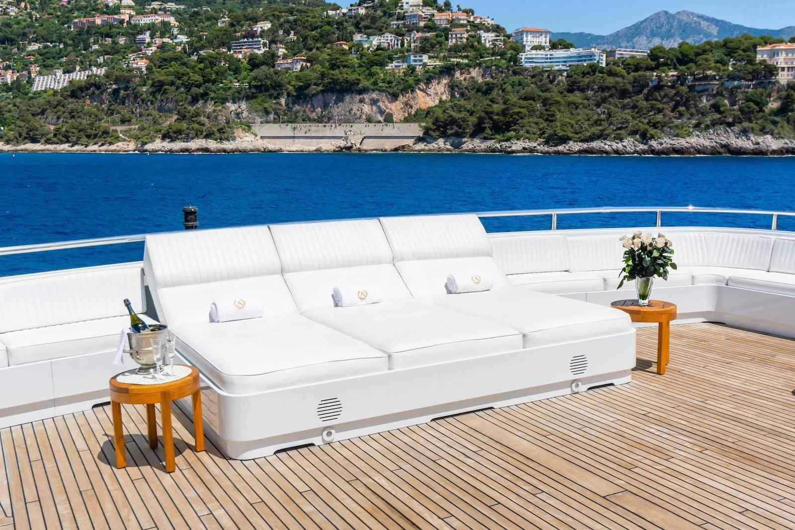 a white bed on a deck aboard APOGEE Yacht for Sale