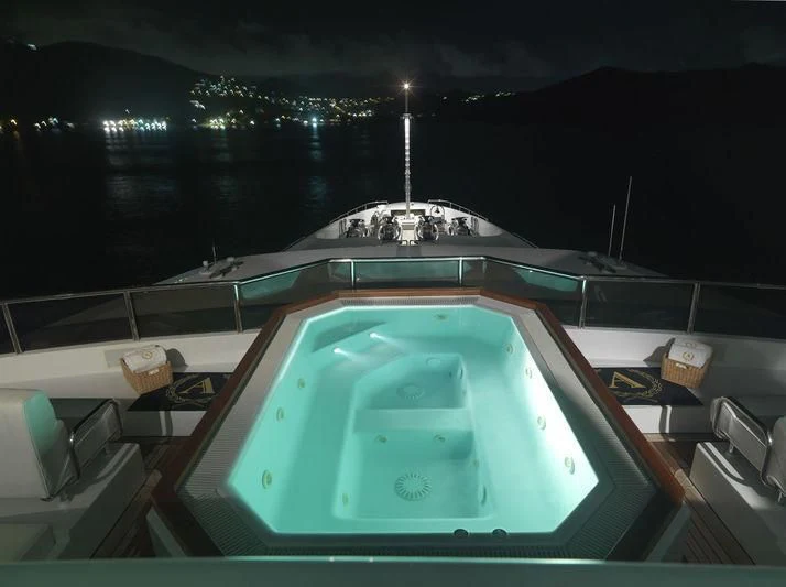 a swimming pool at night aboard APOGEE Yacht for Sale