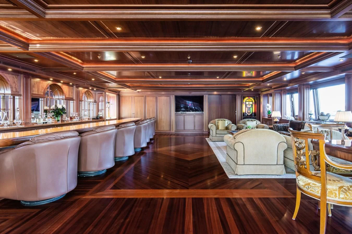 a large room with a large wood floor and a large window aboard APOGEE Yacht for Sale