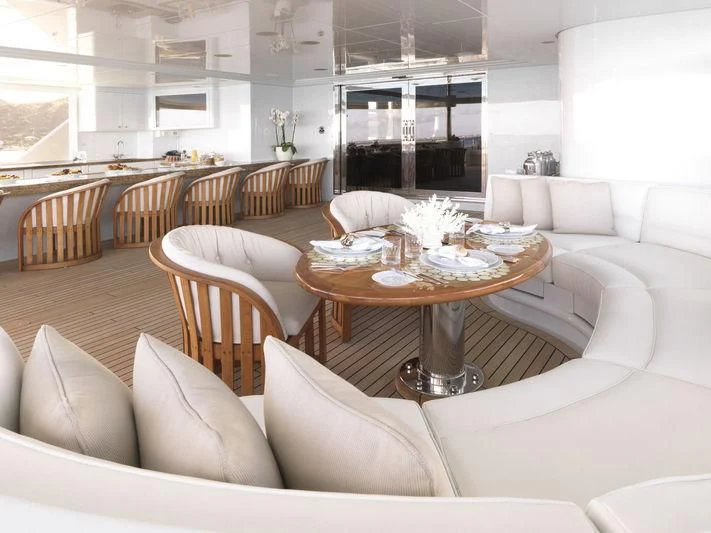 a living room with a table and chairs aboard APOGEE Yacht for Sale