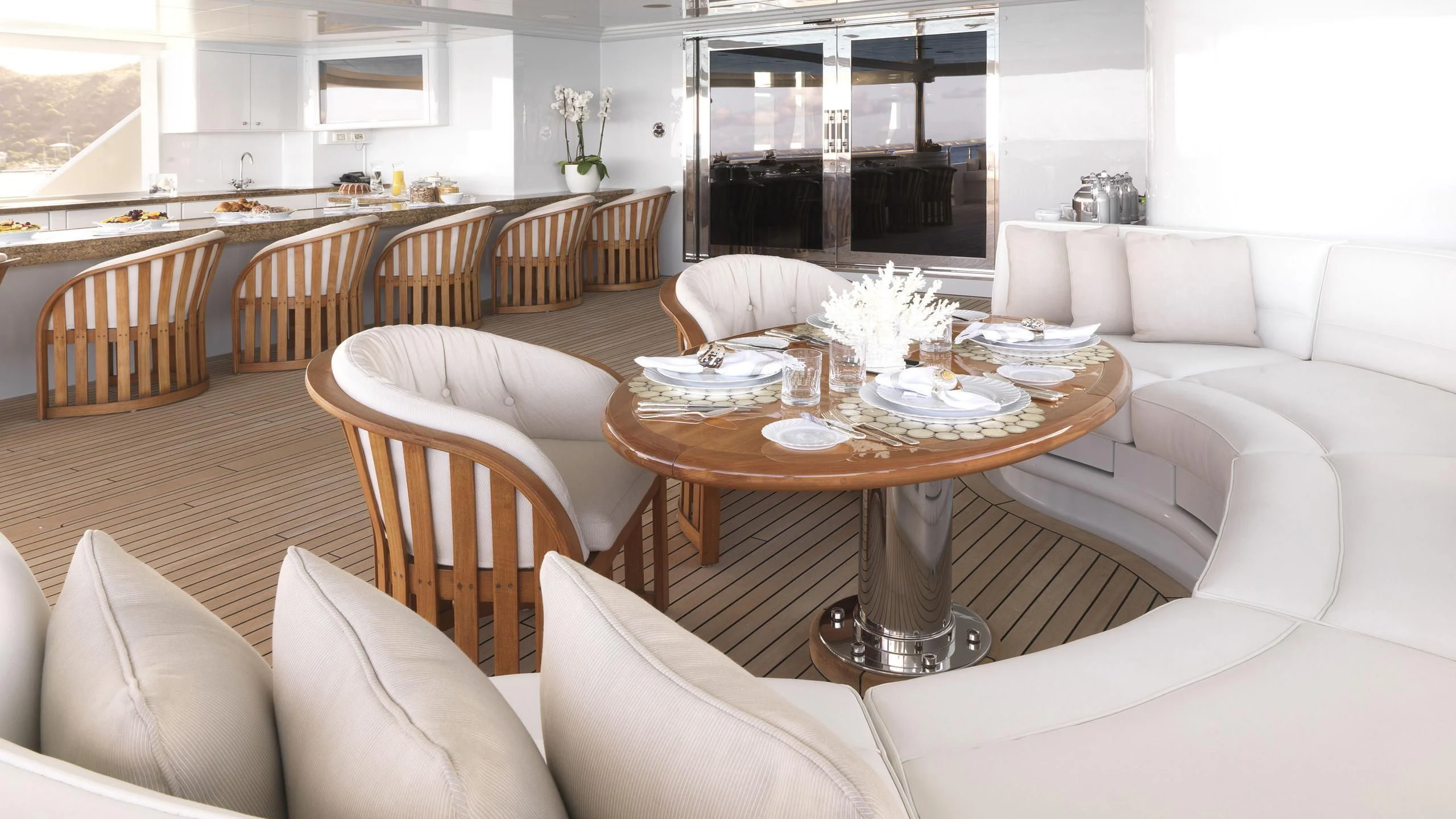 a living room with a table and chairs aboard APOGEE Yacht for Sale