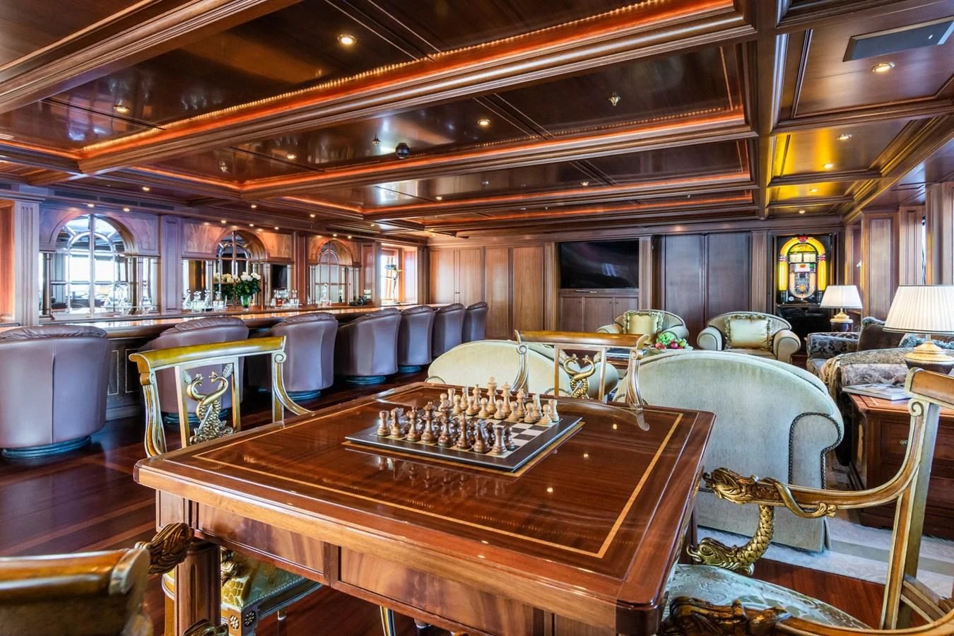 a bar with a table and chairs aboard APOGEE Yacht for Sale