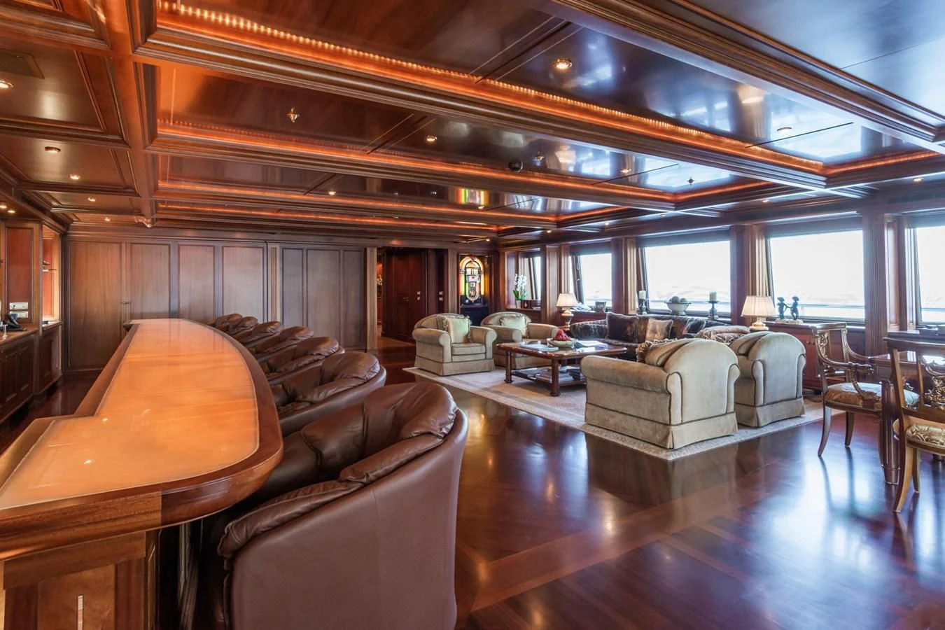 a large living room with a wood floor aboard APOGEE Yacht for Sale