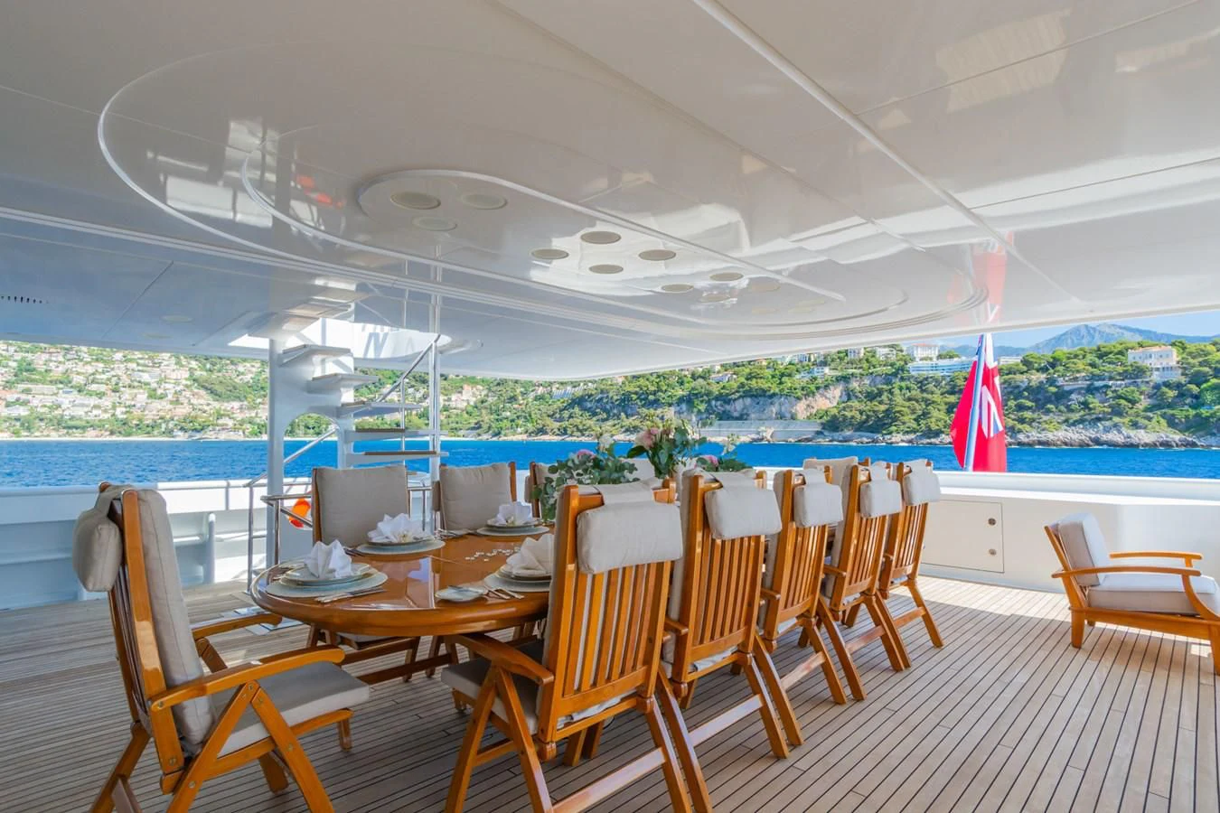a deck with chairs and tables aboard APOGEE Yacht for Sale