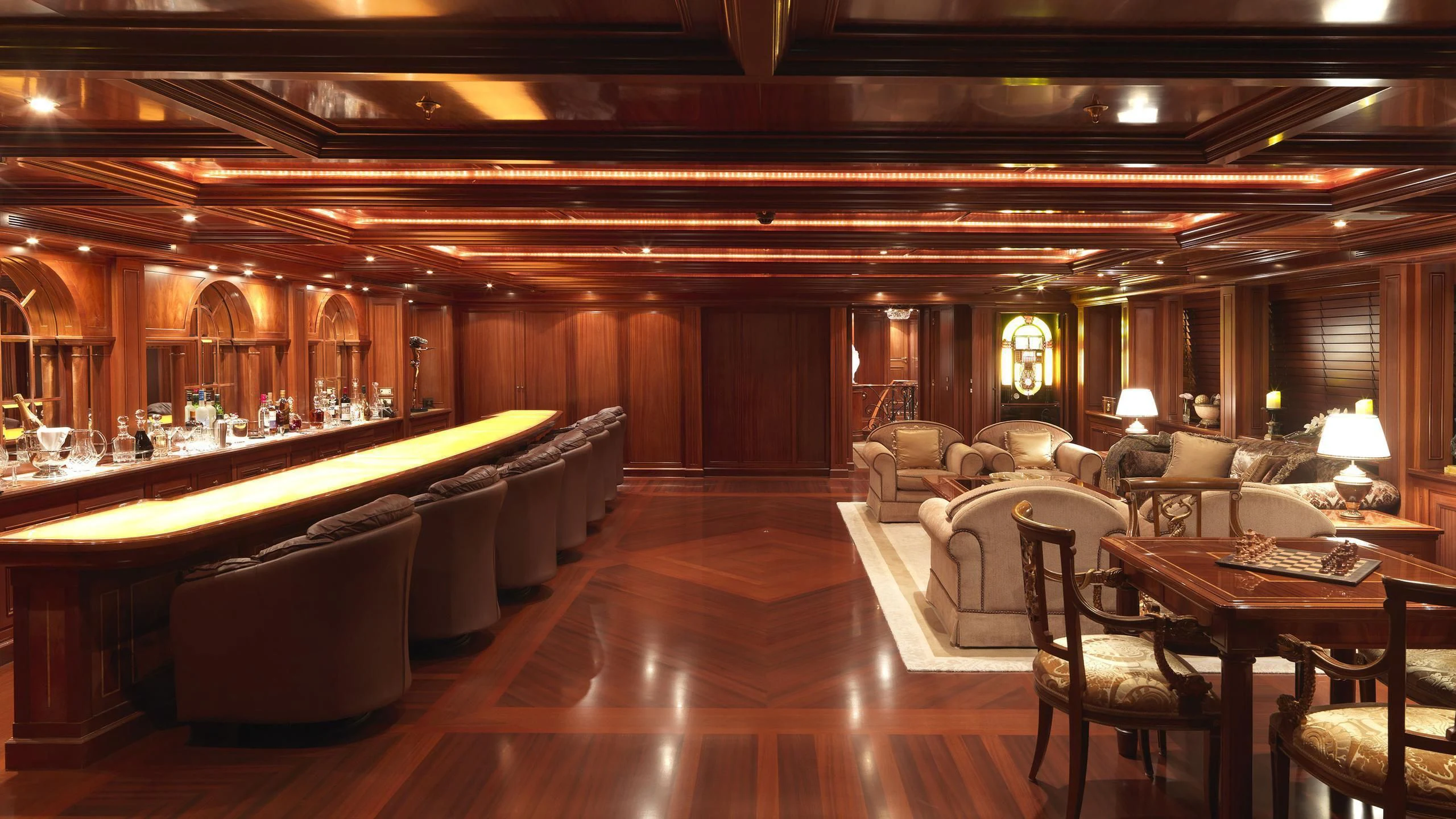 a large living room with a pool table and couches aboard APOGEE Yacht for Sale
