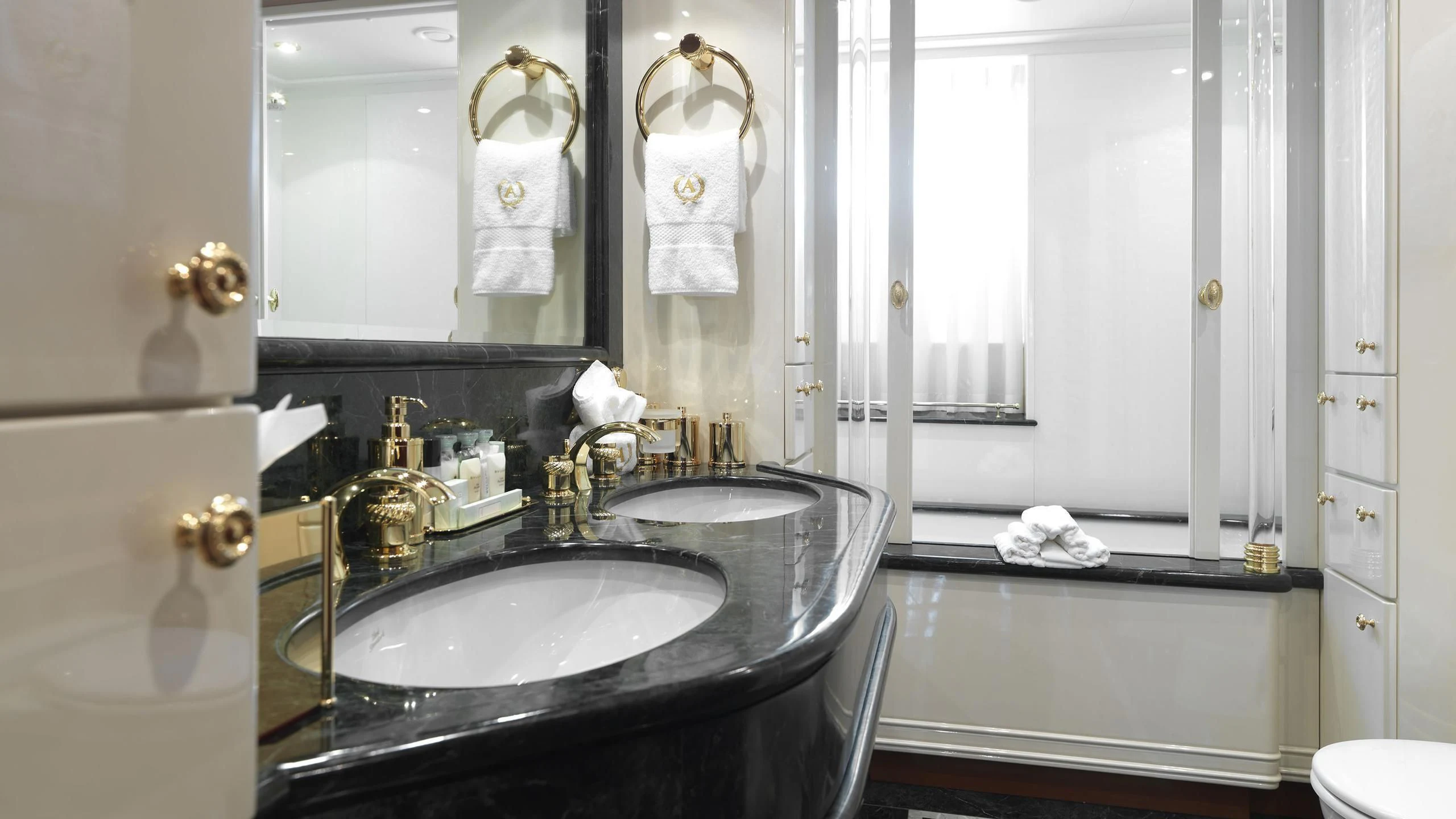 a bathroom with a sink and a mirror aboard APOGEE Yacht for Sale