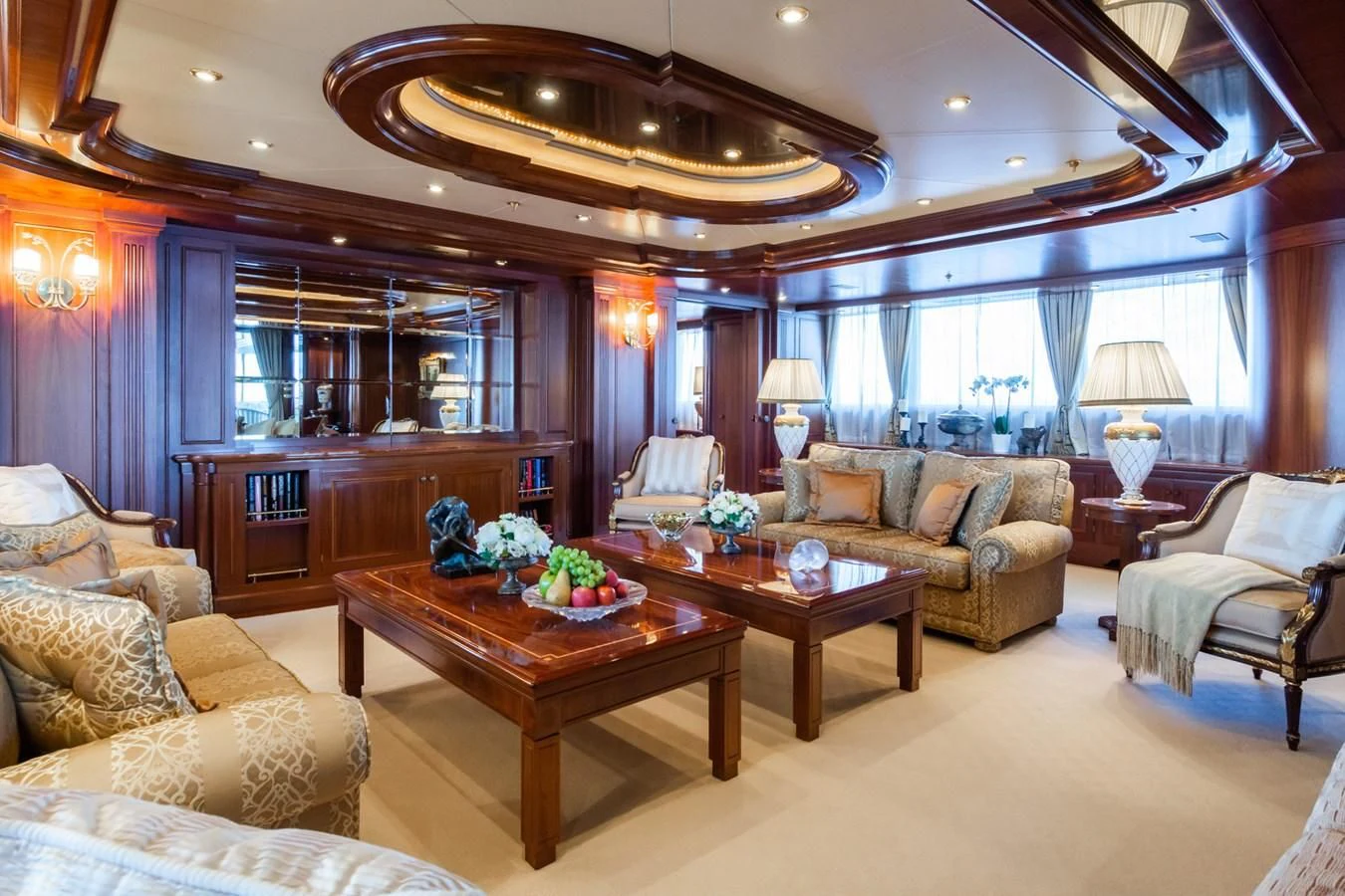 a living room with a large chandelier aboard APOGEE Yacht for Sale