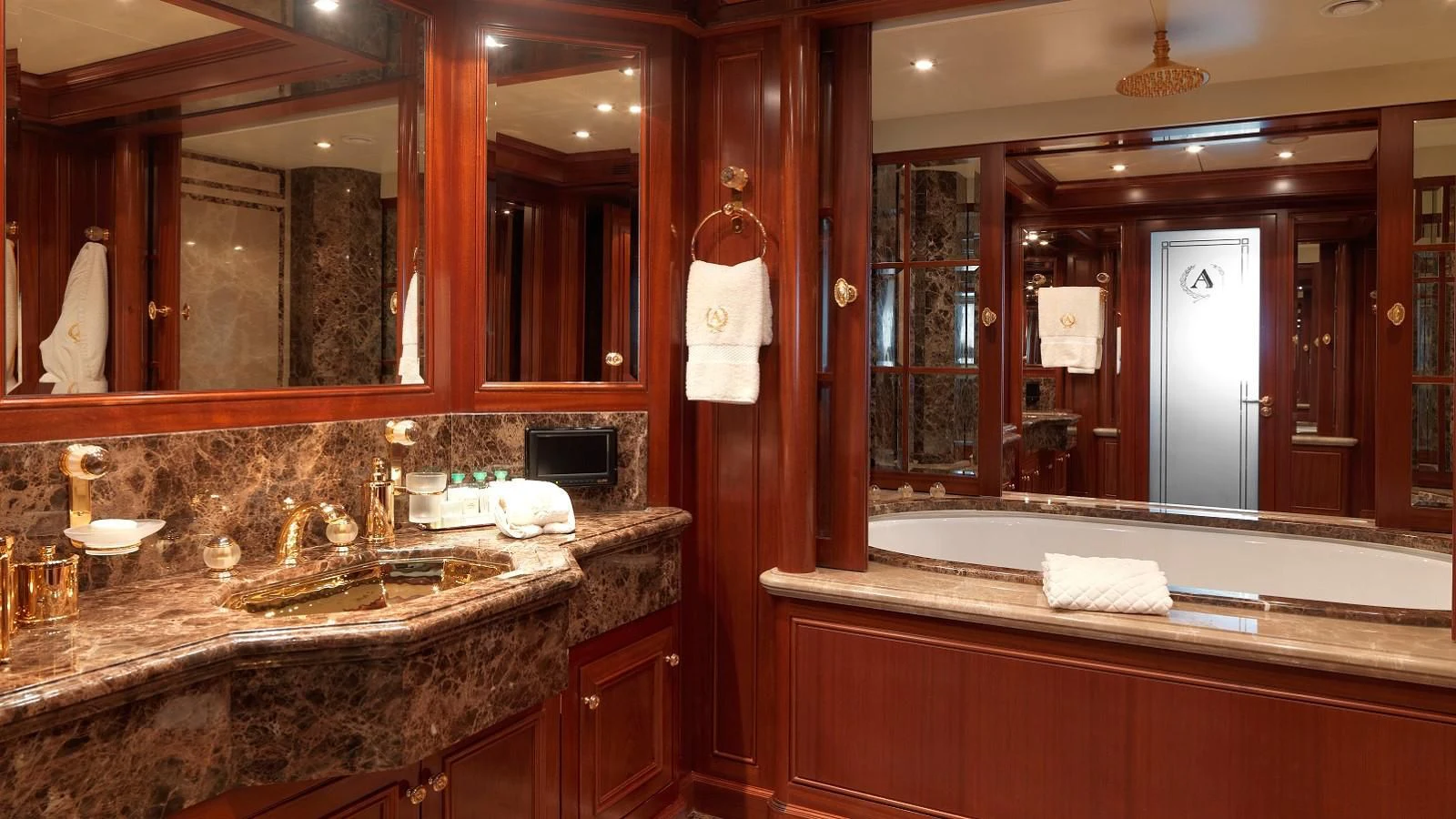 a bathroom with a large mirror aboard APOGEE Yacht for Sale