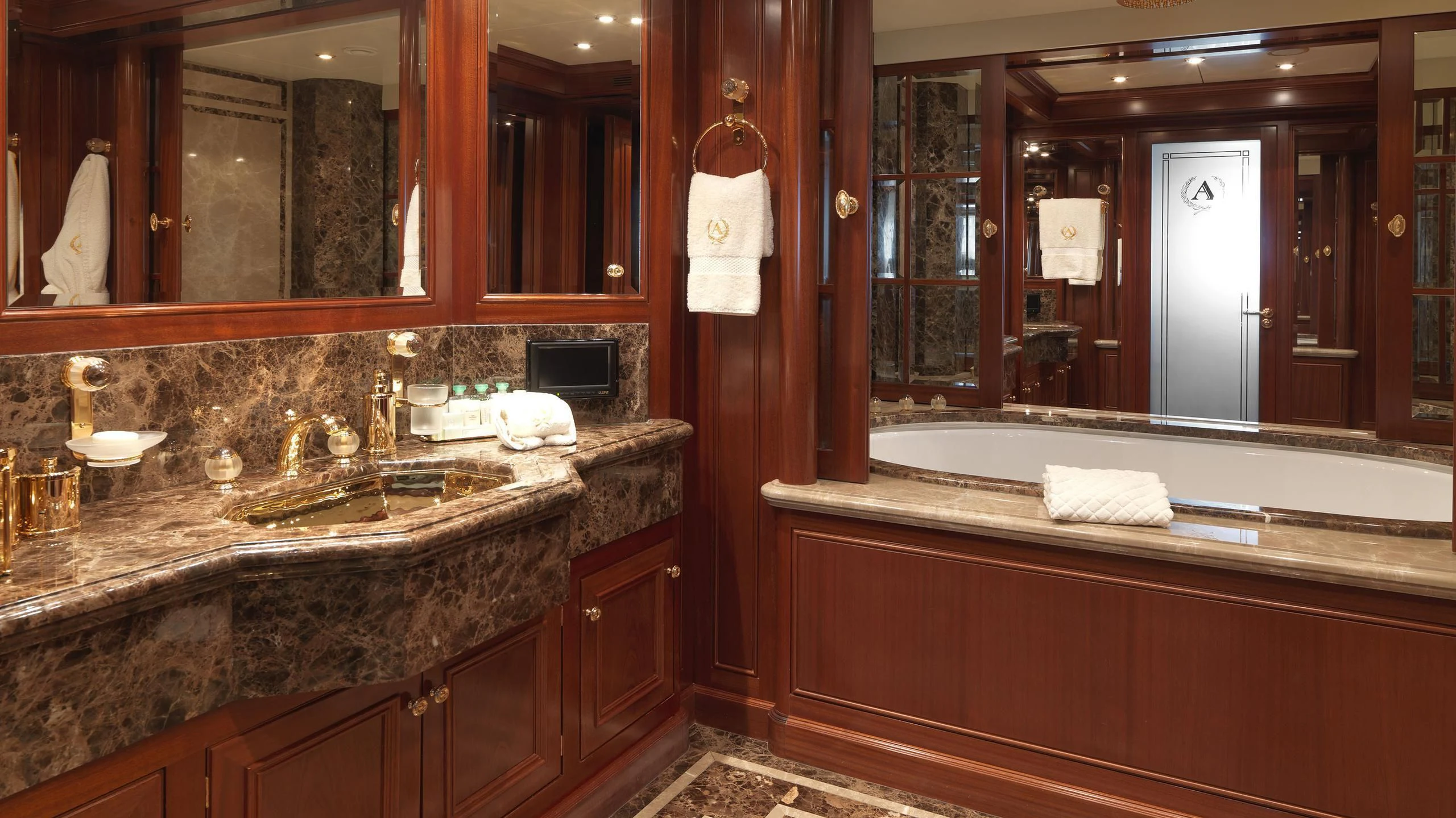 a bathroom with a large mirror aboard APOGEE Yacht for Sale