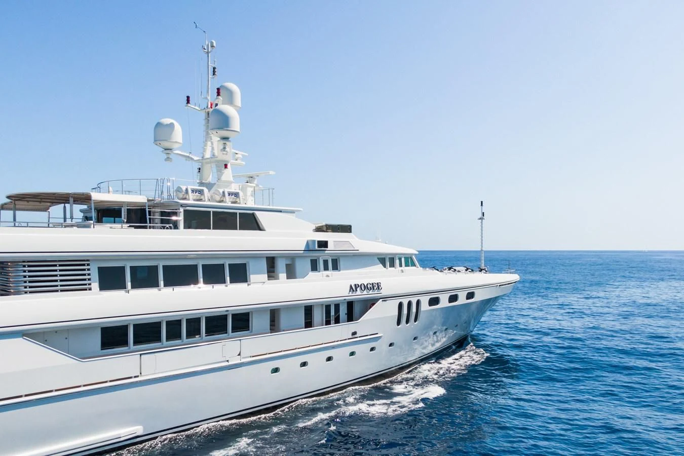 a white boat on the water aboard APOGEE Yacht for Sale