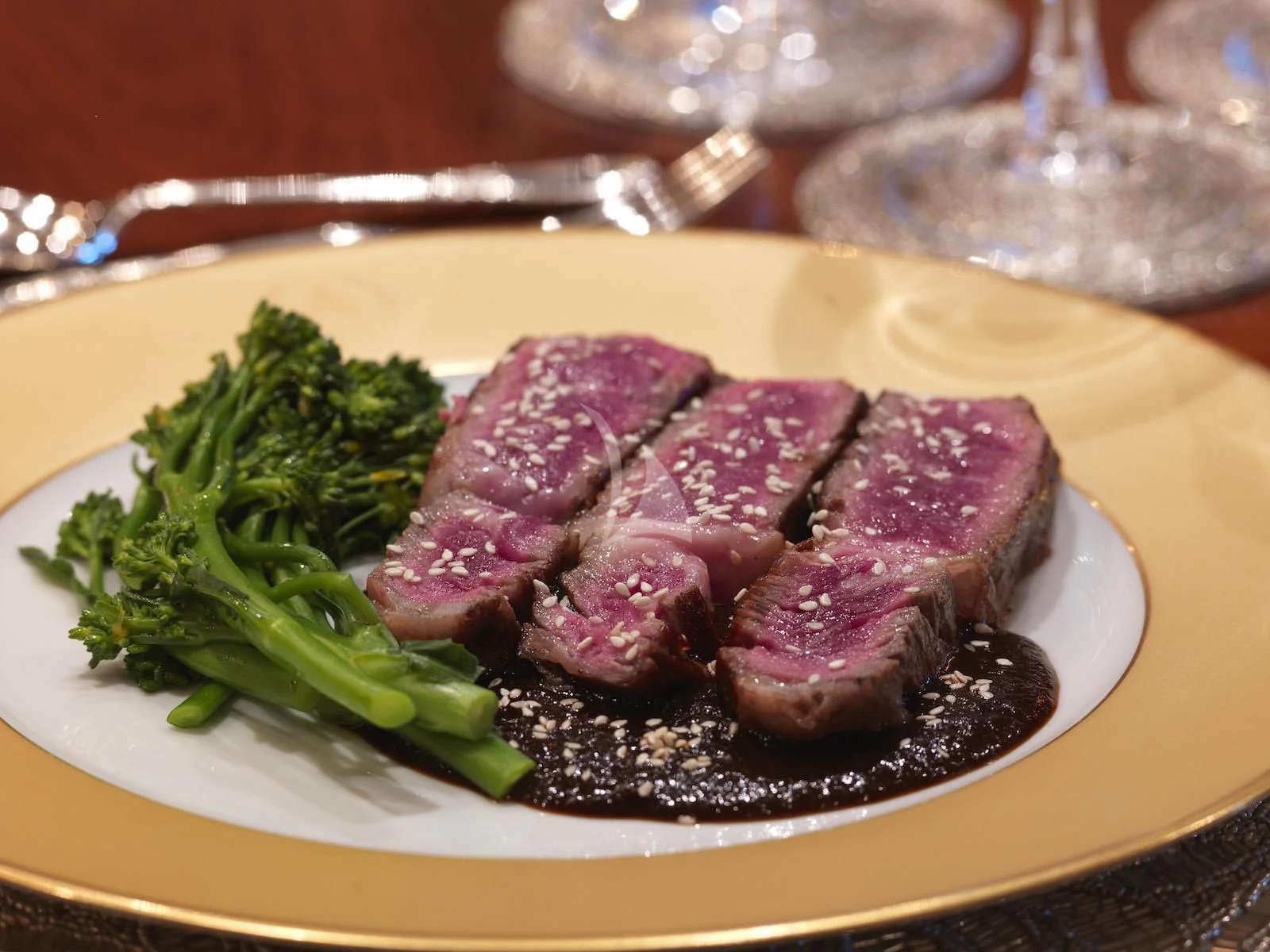 a plate of steak and broccoli aboard APOGEE Yacht for Sale