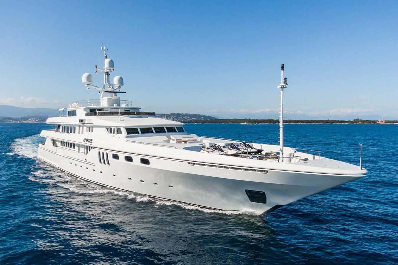 a white yacht on the water aboard APOGEE Yacht for Sale