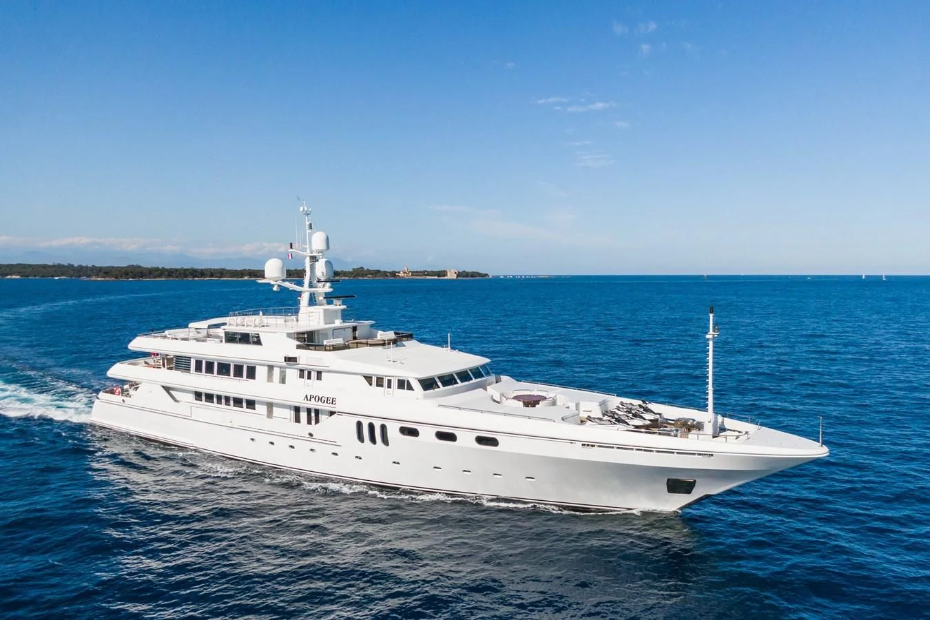 a large white boat in the water aboard APOGEE Yacht for Sale