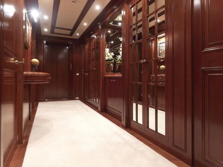 a room with wooden cabinets aboard APOGEE Yacht for Sale