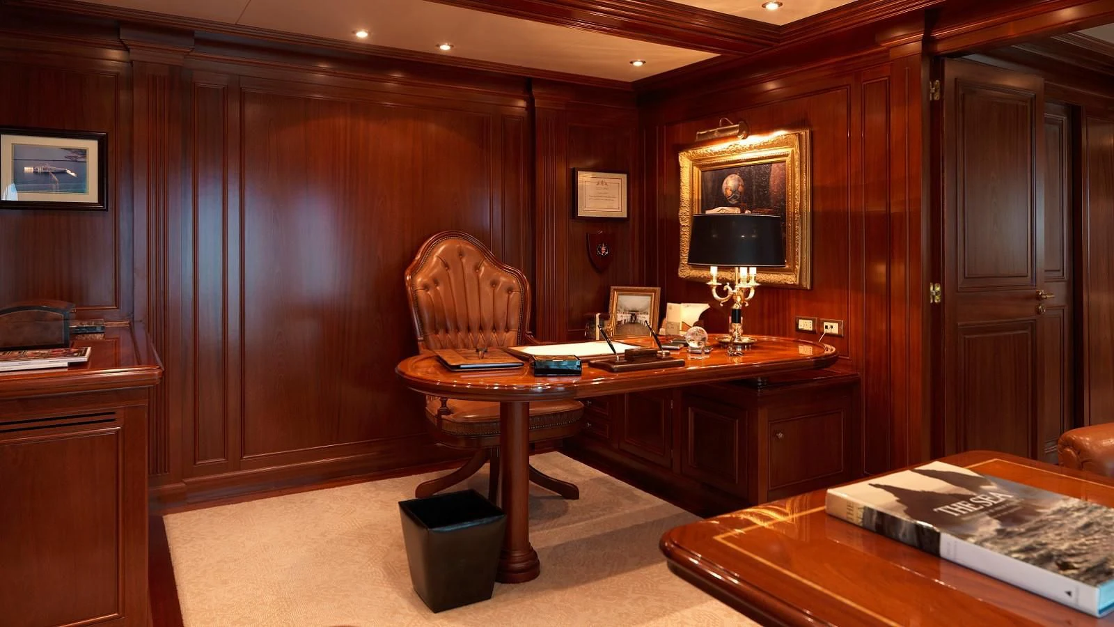 a room with a desk and a television aboard APOGEE Yacht for Sale