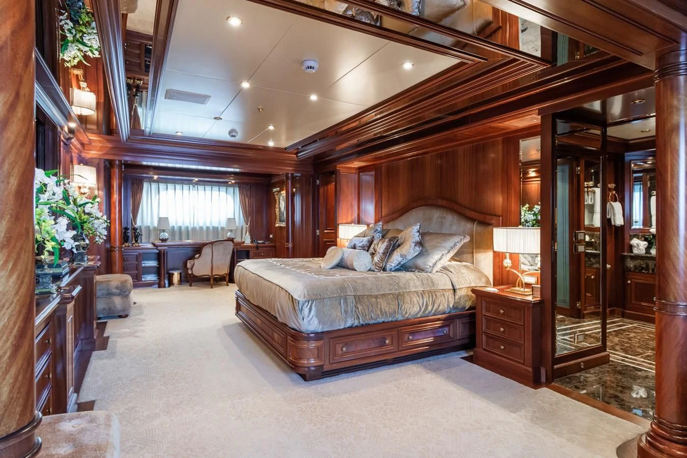 a bedroom with a bed and a desk aboard APOGEE Yacht for Sale