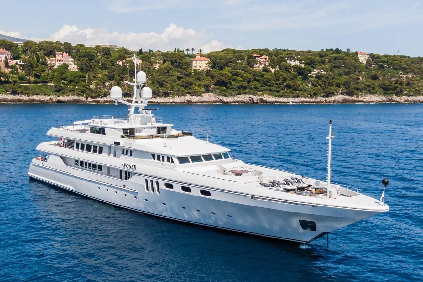 a large white boat in the water aboard APOGEE Yacht for Sale