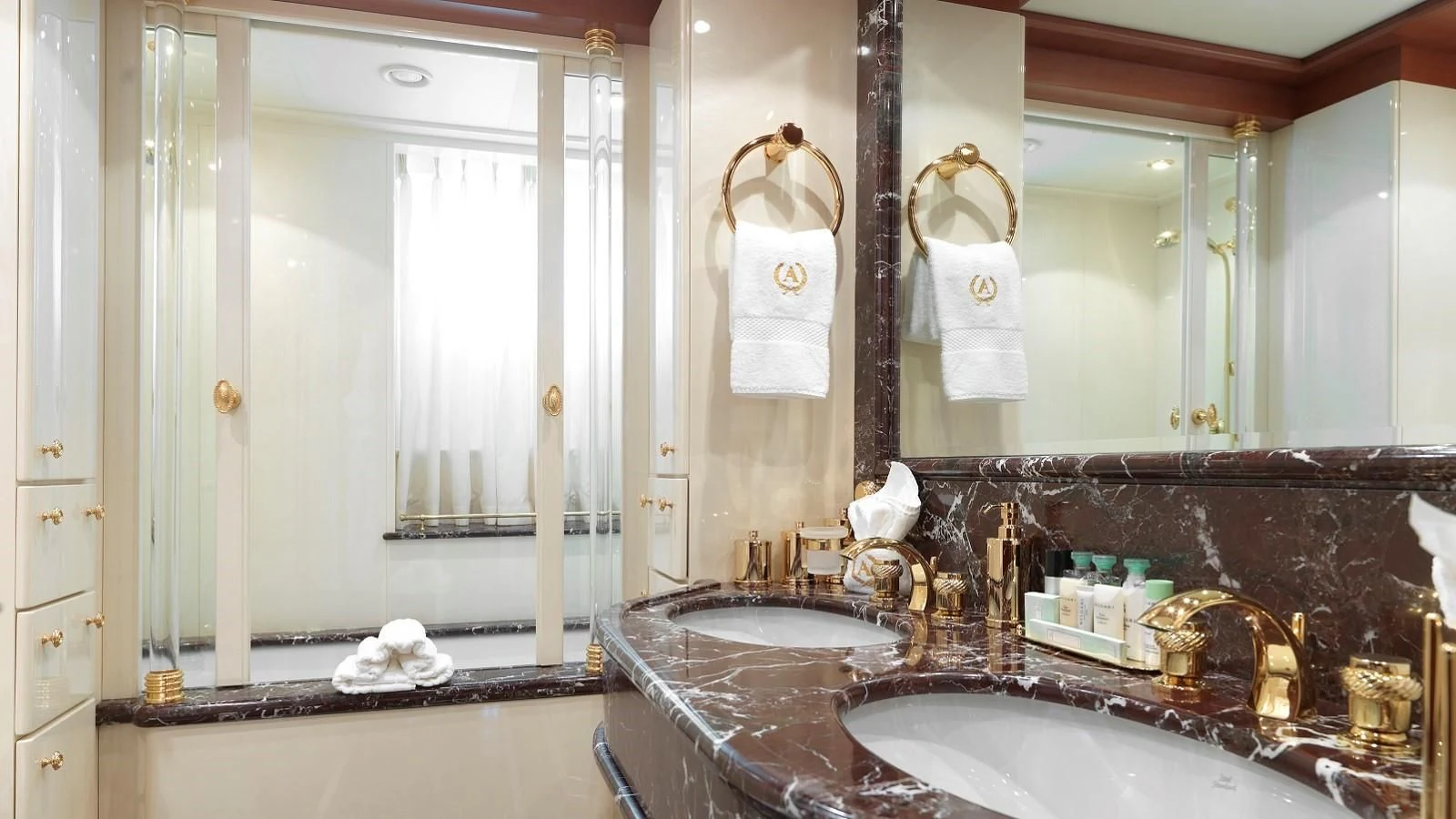 a bathroom with a sink and a large mirror aboard APOGEE Yacht for Sale