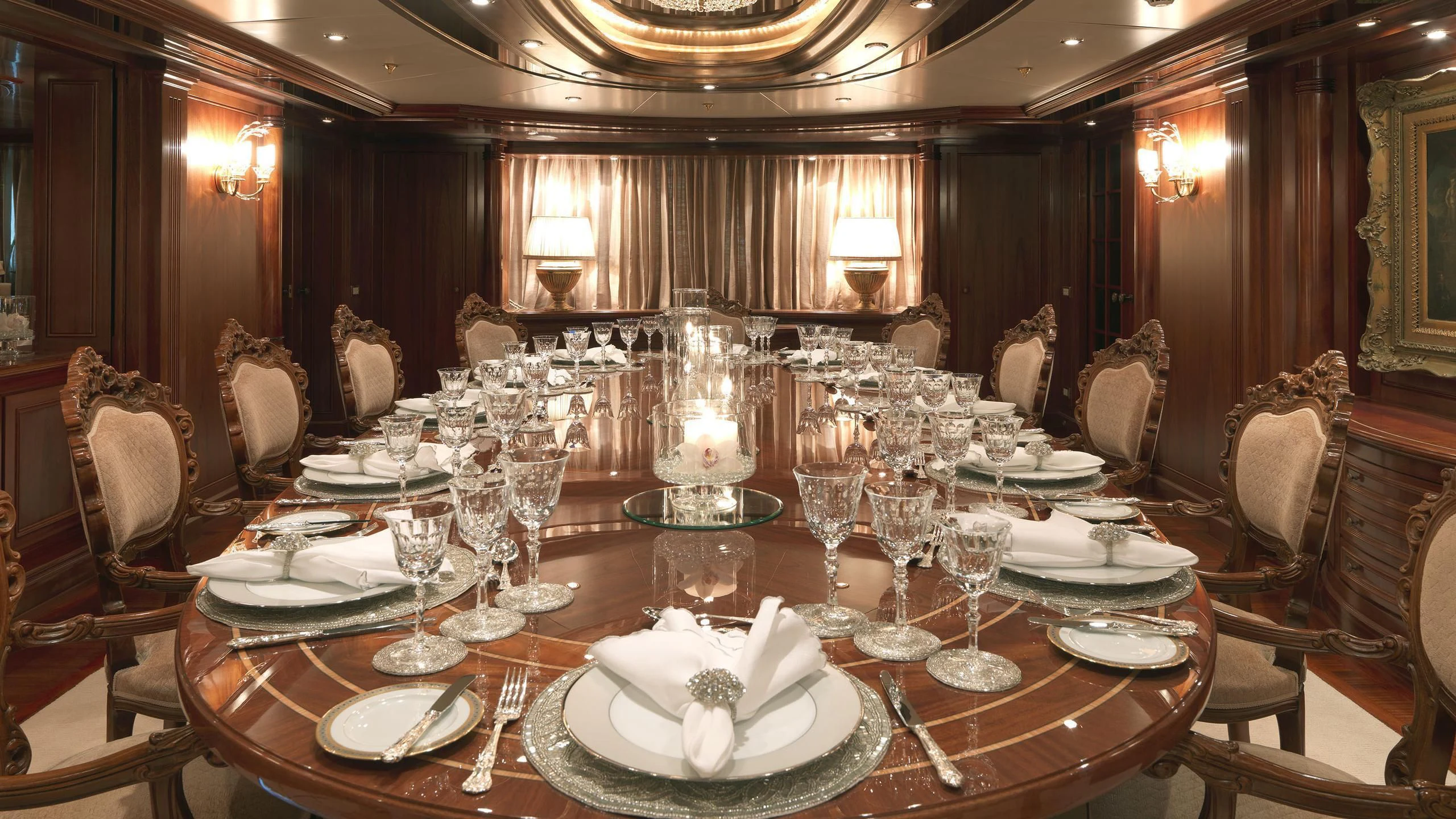 a dining room table set for a formal dinner aboard APOGEE Yacht for Sale